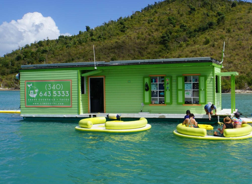 Building in the ocean selling food and drinks to people in seats in the water